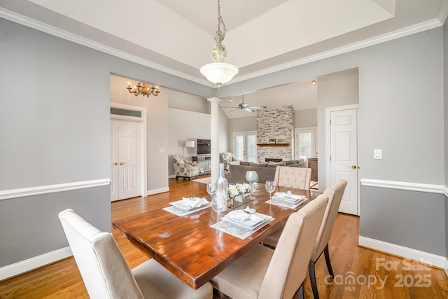 180 Sink Farm Rd, Mooresville, NC 28115 - dining area featuring a ceiling fan, baseboards, a fireplace, and light wood finished floors