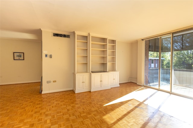 unfurnished living room with crown molding and light parquet floors