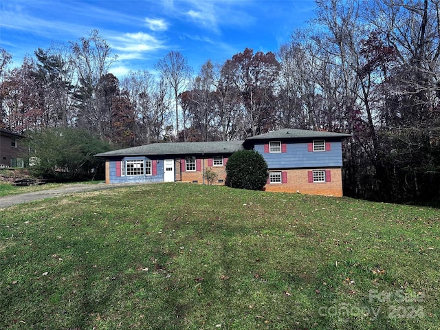 tri-level home with a front yard