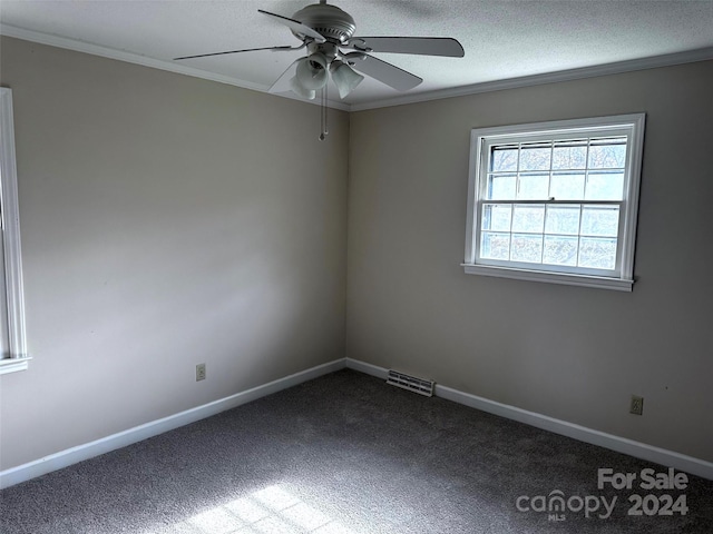 carpeted empty room featuring a textured ceiling, ceiling fan, and crown molding