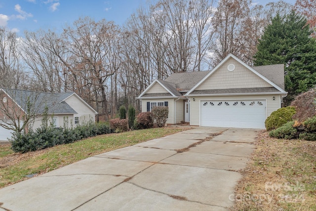 view of front of property with a garage and a front lawn