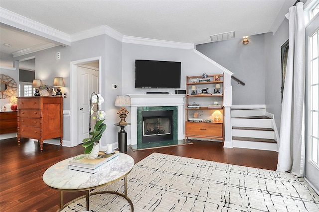 living room featuring a healthy amount of sunlight, crown molding, and dark wood-type flooring