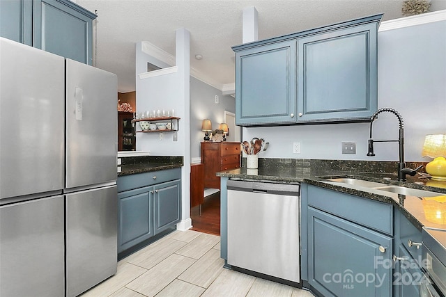 kitchen with crown molding, sink, light hardwood / wood-style flooring, blue cabinetry, and appliances with stainless steel finishes