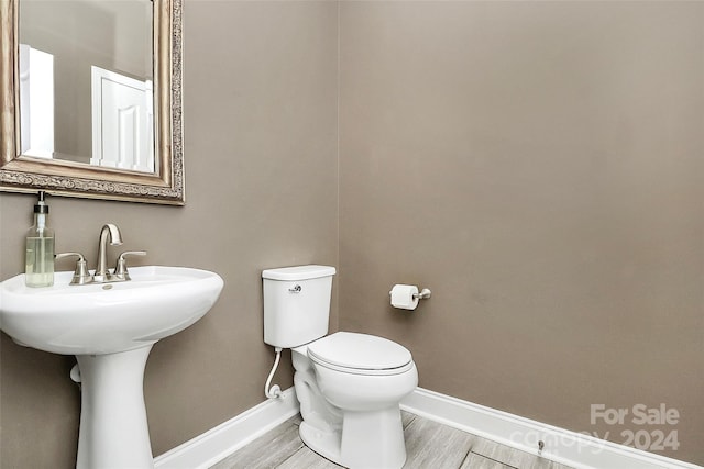 bathroom featuring hardwood / wood-style floors and toilet