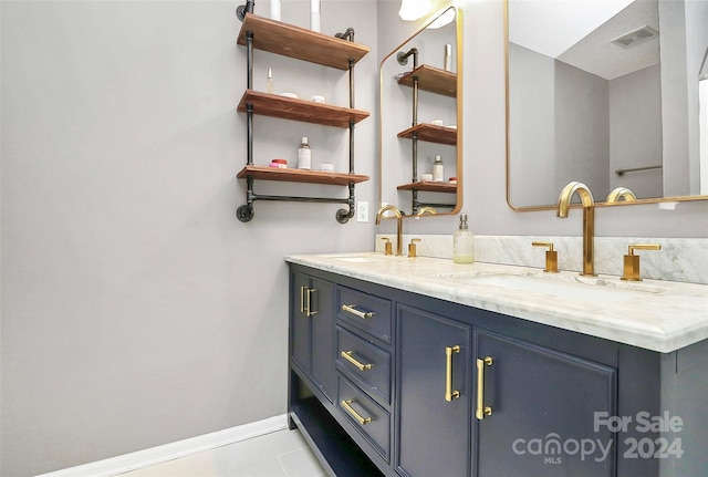 bathroom with tile patterned floors and vanity