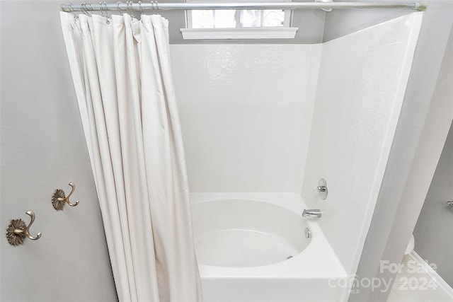 bathroom featuring shower / bath combination with curtain