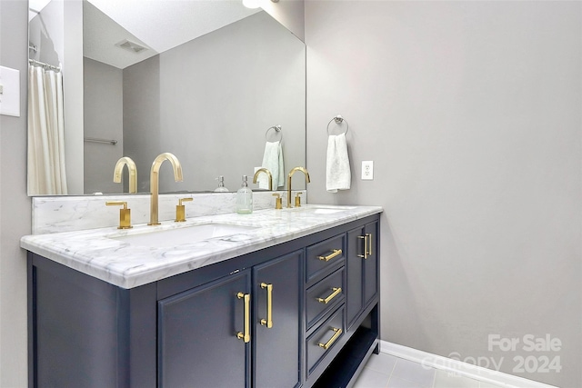 bathroom with tile patterned flooring and vanity