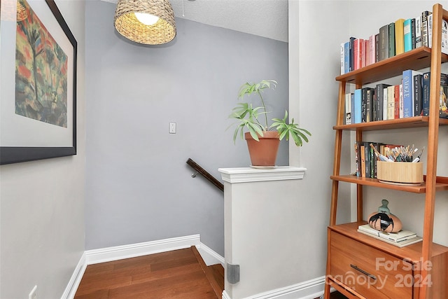 stairs featuring hardwood / wood-style floors and a textured ceiling