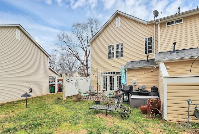 rear view of property featuring a yard