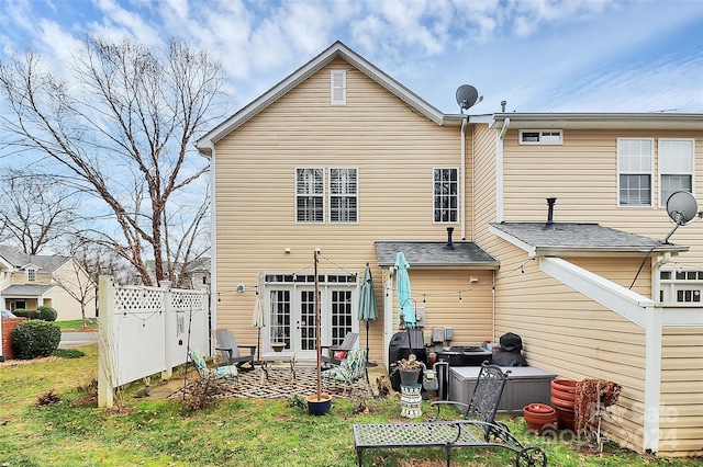 back of property with a patio area and french doors