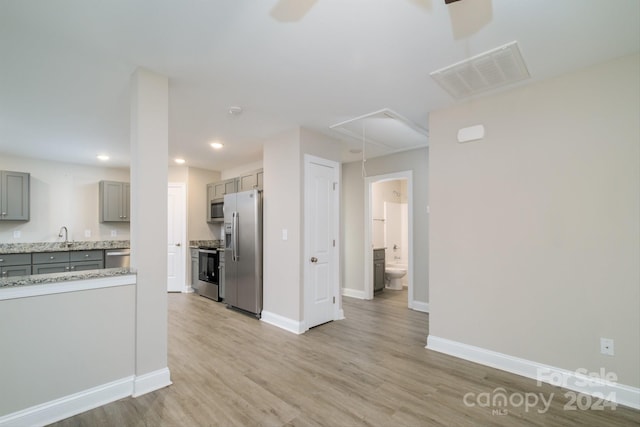 kitchen featuring gray cabinetry, sink, appliances with stainless steel finishes, and light hardwood / wood-style flooring