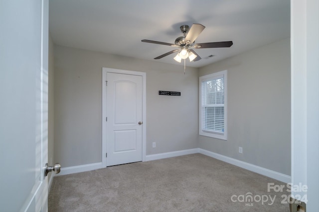 carpeted empty room with ceiling fan