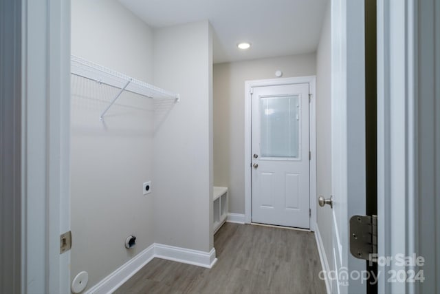 laundry room featuring light hardwood / wood-style floors and hookup for an electric dryer