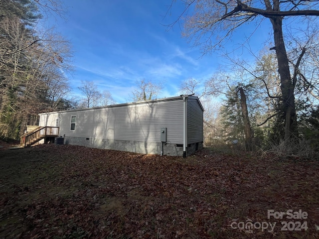 rear view of house featuring central AC