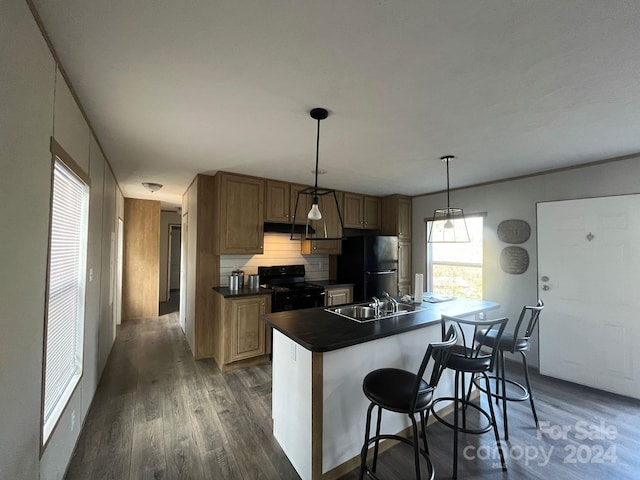 kitchen with stainless steel refrigerator, dark hardwood / wood-style floors, backsplash, pendant lighting, and black range