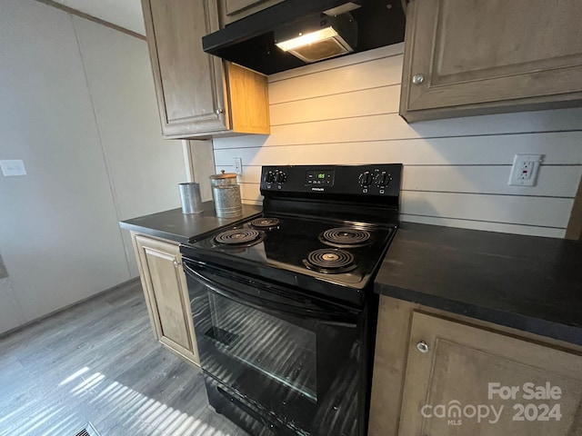 kitchen with light wood-type flooring and black / electric stove