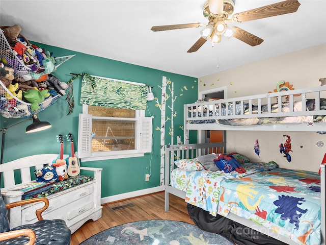 bedroom with ceiling fan and hardwood / wood-style floors