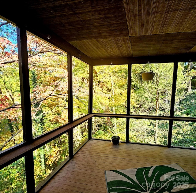 unfurnished sunroom featuring wooden ceiling