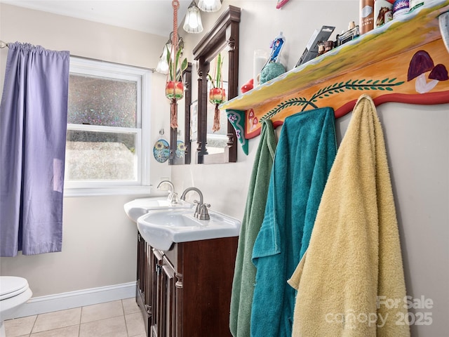 bathroom featuring tile patterned flooring, vanity, toilet, and baseboards