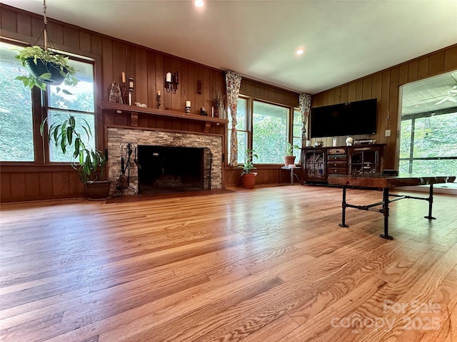 81 Jericho Dr, Tryon, NC 28782 - living area with wood walls, light wood-type flooring, healthy amount of natural light, and a fireplace