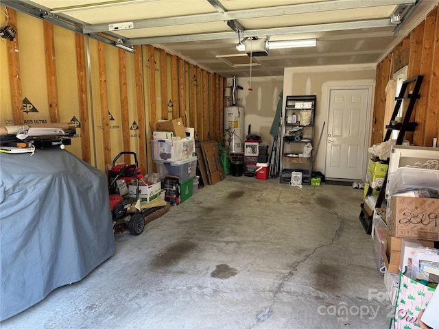 garage featuring a garage door opener and water heater