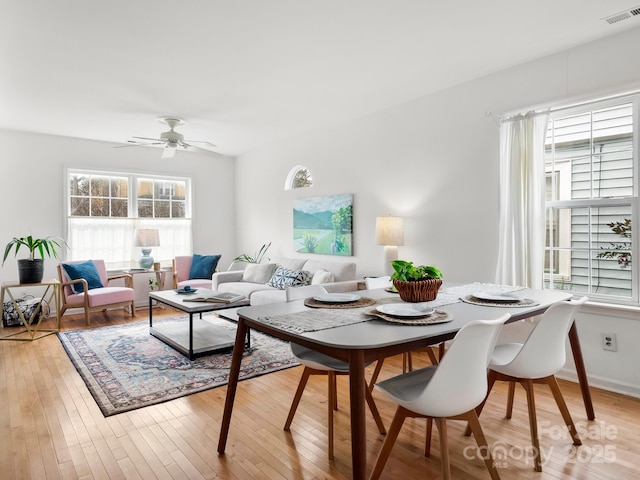 living room with ceiling fan and light hardwood / wood-style floors