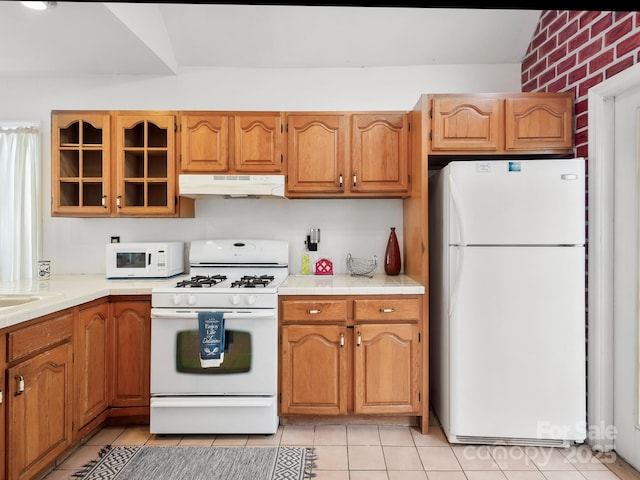 kitchen with white appliances and light tile patterned floors