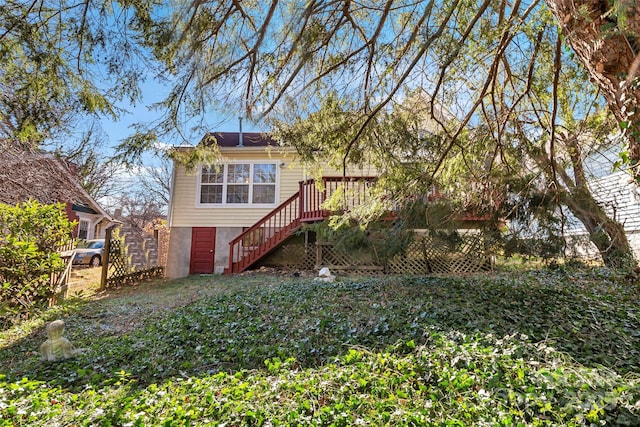 back of property with a wooden deck