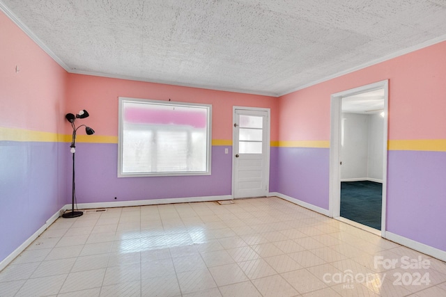 interior space featuring a textured ceiling, light tile patterned flooring, and crown molding