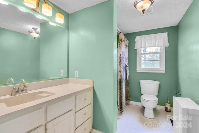 bathroom featuring vanity, toilet, a textured ceiling, and walk in shower