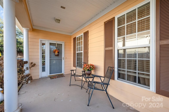 view of exterior entry featuring covered porch