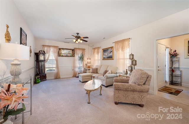 carpeted living room featuring ceiling fan