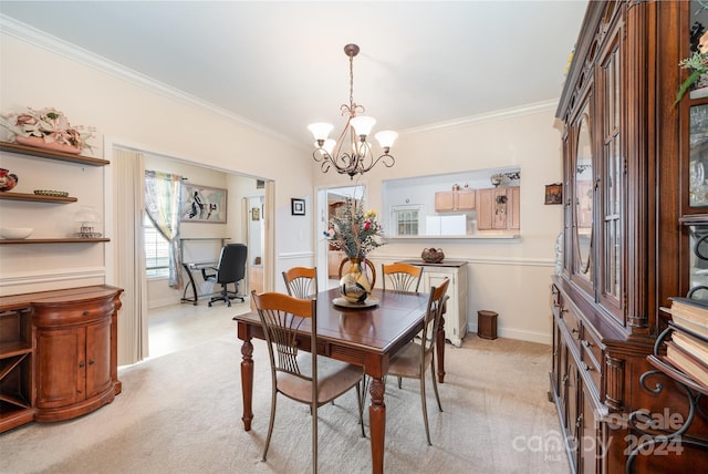 carpeted dining room with ornamental molding and an inviting chandelier