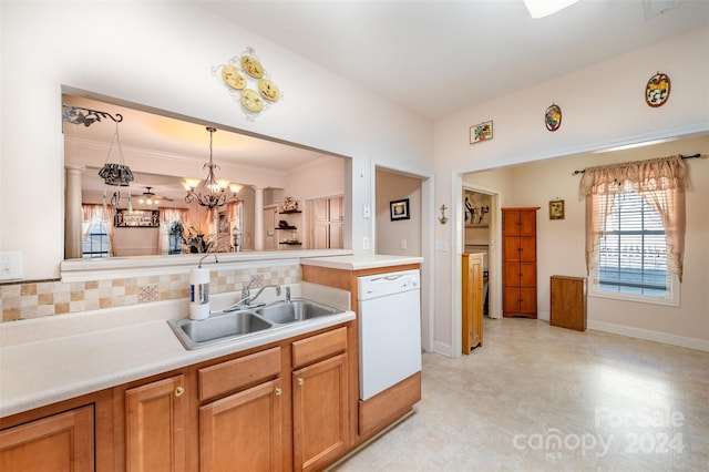 kitchen with kitchen peninsula, white dishwasher, sink, an inviting chandelier, and hanging light fixtures