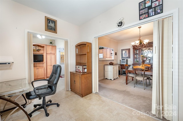 carpeted home office featuring a notable chandelier and ornamental molding