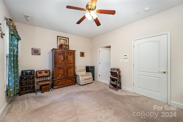 living area featuring ceiling fan and light colored carpet