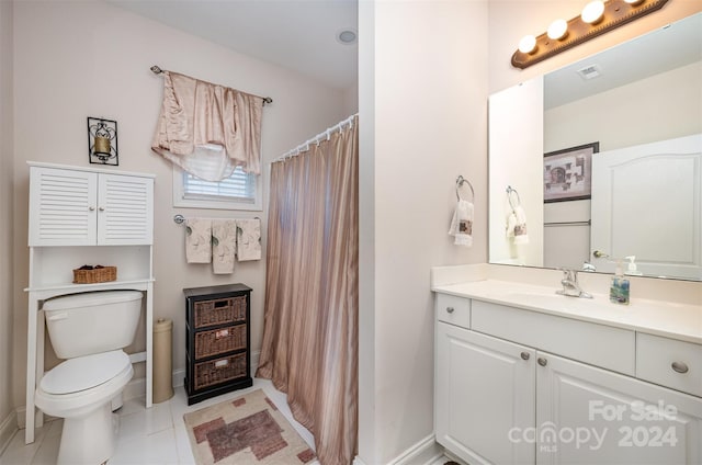 bathroom featuring tile patterned floors, vanity, and toilet