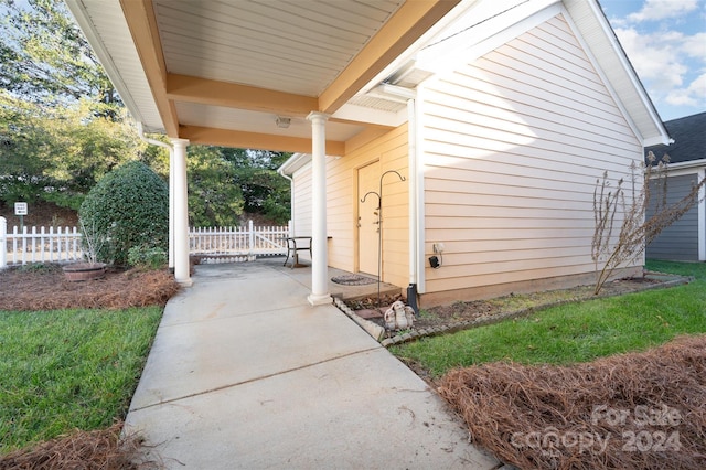 view of side of home with covered porch