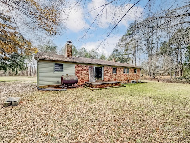 rear view of property with a lawn and a patio area