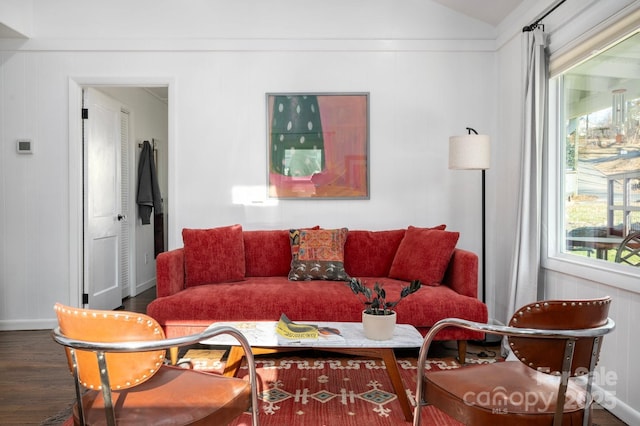 living room featuring vaulted ceiling and dark wood-type flooring