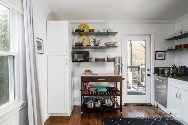 kitchen with white cabinetry, stainless steel dishwasher, dark hardwood / wood-style floors, dark stone countertops, and crown molding