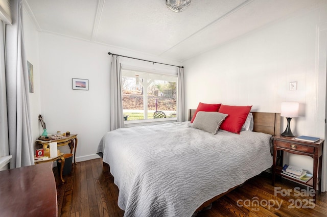 bedroom featuring dark hardwood / wood-style floors, a textured ceiling, and vaulted ceiling