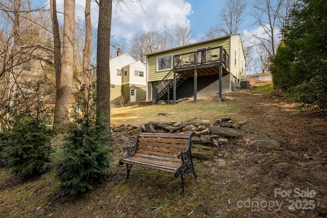 back of house featuring a deck and central AC unit