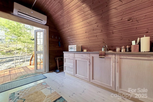 interior space featuring a wall mounted air conditioner, hardwood / wood-style flooring, wooden walls, and vaulted ceiling