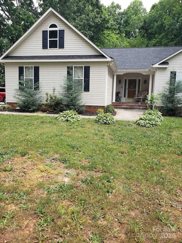 rear view of property featuring a yard