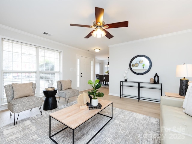 living room featuring hardwood / wood-style floors, ornamental molding, and ceiling fan