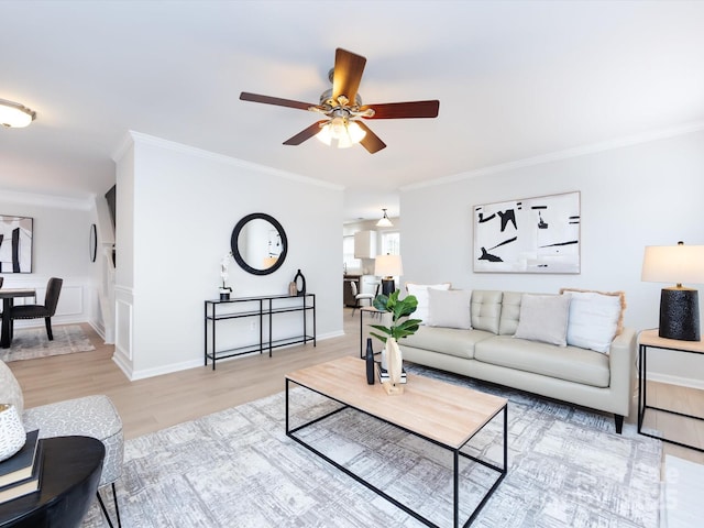 living room with crown molding, ceiling fan, and hardwood / wood-style floors