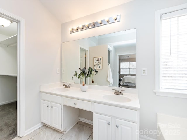 bathroom with vanity, tile patterned floors, and lofted ceiling