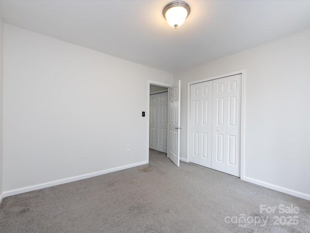 unfurnished bedroom featuring a closet and carpet