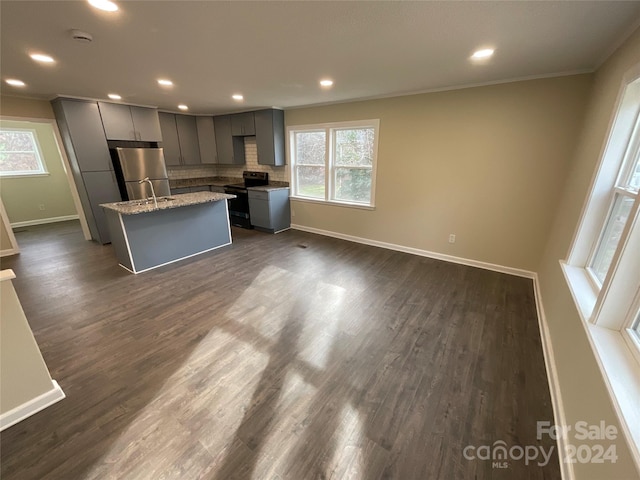 kitchen with a center island, dark hardwood / wood-style floors, gray cabinets, appliances with stainless steel finishes, and ornamental molding